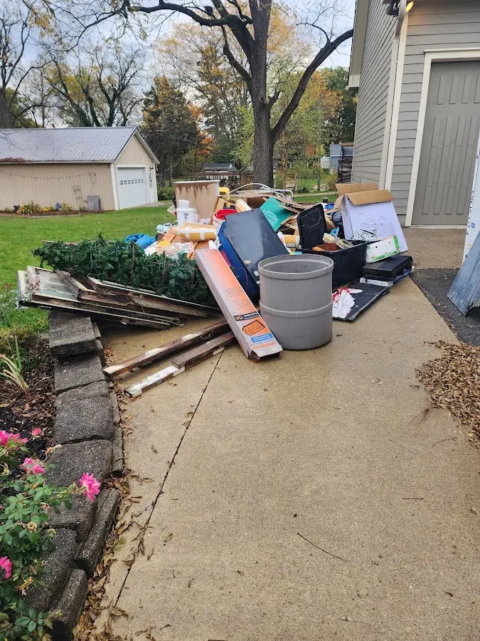 Dumpster being loaded with debris for 12 Yard Dumpster Rental in Bridgetown